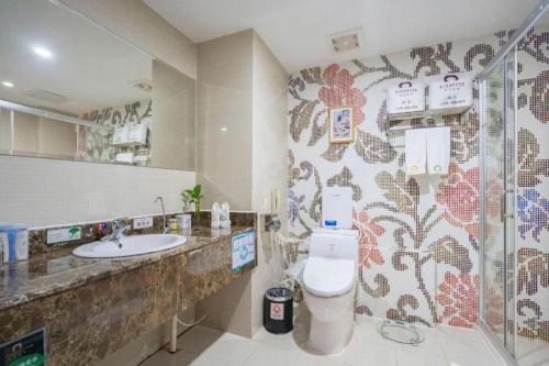 a bathroom with a toilet and a sink at Xiamen Plaza Hotel in Xiamen