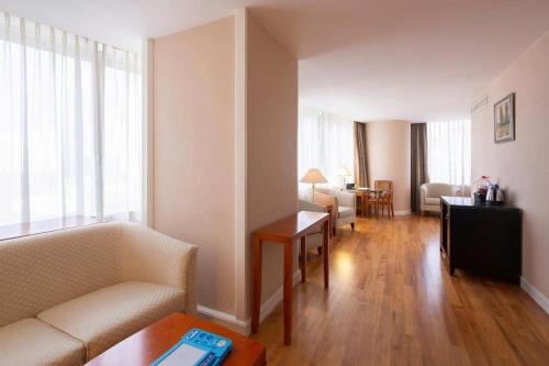 a living room with a couch and a table at Kai Wah Plaza International Hotel in Kunming