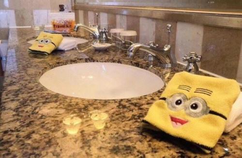 a bathroom with a sink with two towels with faces on it at Kai Wah Plaza International Hotel in Kunming