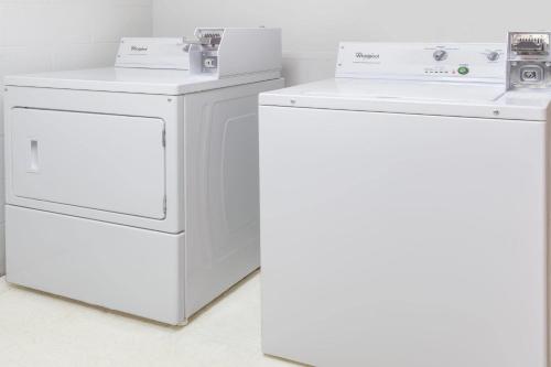 two whitewashes and a washing machine in a room at Super 8 by Wyndham Logansport in Logansport