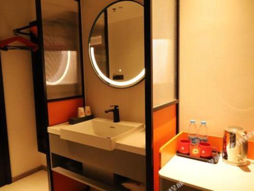 a bathroom with a sink and a mirror at ibis Dongguan Dongcheng in Dongguan