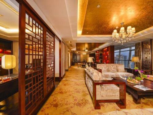 a living room with a couch and a table at Gaosu New Century Hotel International Anhui in Hefei
