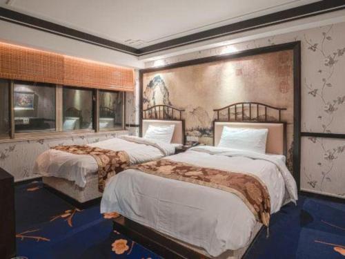 Кровать или кровати в номере Hangzhou Qiao Garden Vacation Hotel