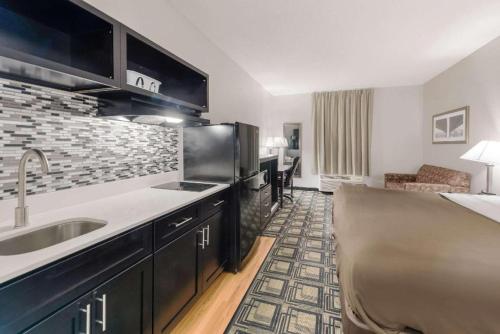 a kitchen with a sink and a counter top at Suburban Studios Mason Hwy 42 in Mason