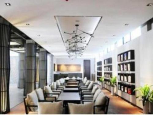 a long room with a long table and chairs at H Life Hotel Nanshan Branch in Shenzhen