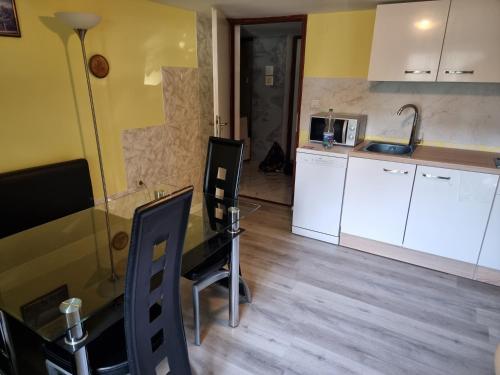 a kitchen with a table and chairs in a room at Holiday Home in Velika Mlaka