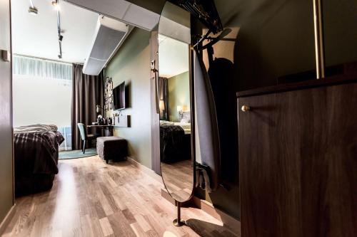 a large mirror in a room with a bedroom at Scandic Uplandia in Uppsala