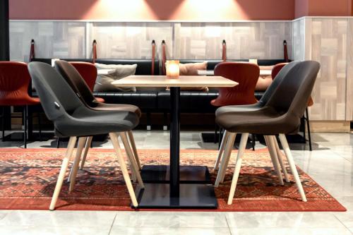 a dining room with a table and chairs at Scandic Uplandia in Uppsala