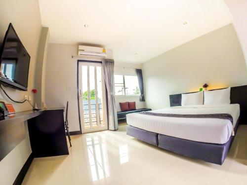 a large bedroom with a large bed and a television at My Place Phuket Airport Mansion in Patong Beach
