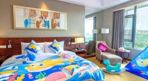 a bedroom with a large bed with a fish themed bedspread at Quanzhou Guest House Hotel in Quanzhou