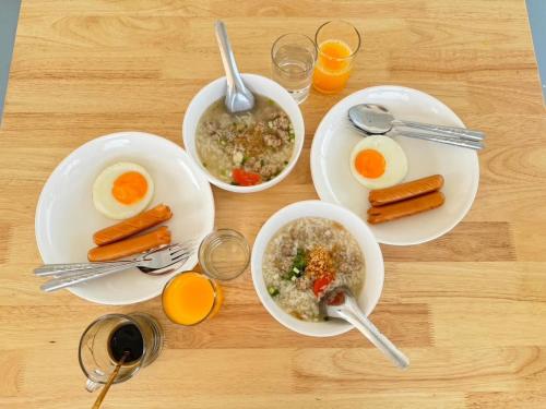 a table with three plates of food with carrots and eggs at Nordic Hills Kanchanaburi in Ban Chek