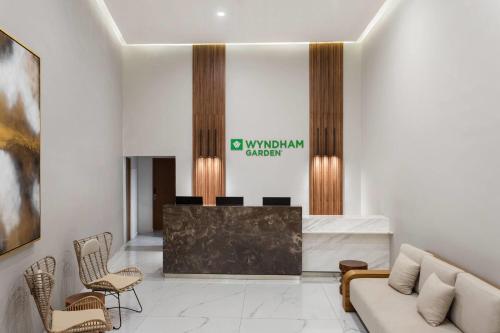a lobby with a reception desk and chairs at Wyndham Garden Mazatlan Marina in Mazatlán