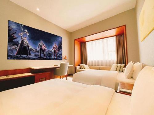 a hotel room with two beds and a painting on the wall at Deacon House Wuxi in Wuxi