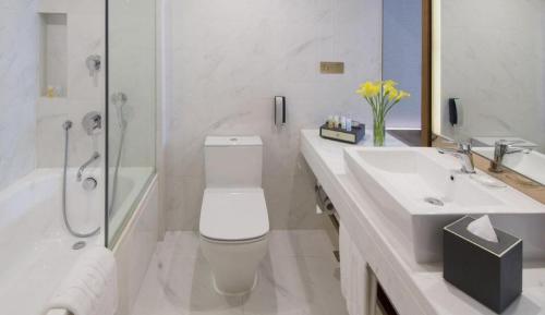 a bathroom with a toilet and a sink and a shower at Deacon House Wuxi in Wuxi
