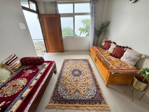 a living room with two beds and a window at Fog & Fern in Kurseong