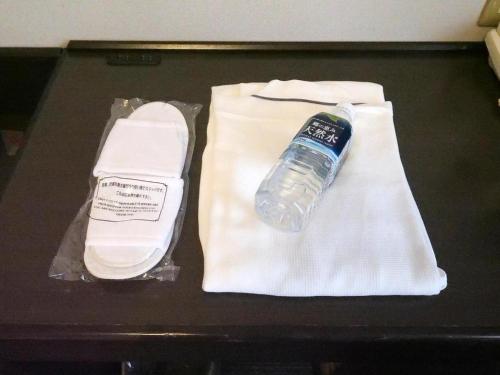 a bottle of water sitting on top of a towel at Green Hotel Yes Nagahama Minatokan in Nagahama