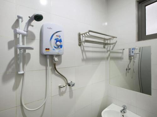 a bathroom with a shower and a toilet and a mirror at Hotel Zamburger Sungai Besi in Kuala Lumpur