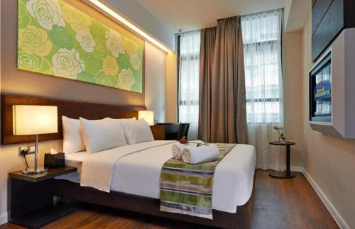 a hotel room with a large bed and a television at Centrestage Petaling Jaya in Kuala Lumpur