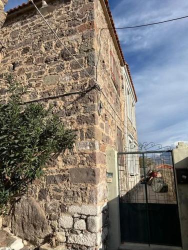 a brick building with a gate on the side of it at Castellum ac Mare in Mithymna
