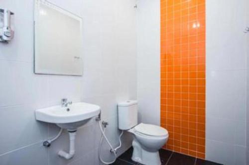 a bathroom with a toilet and a sink at Big Orange Hotel Jitra in Alor Setar