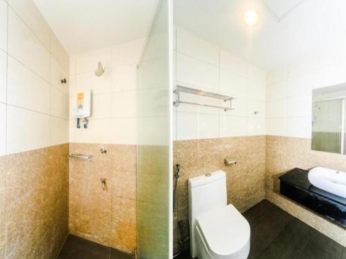 a bathroom with a toilet and a sink at Bay Hotel in Lahad Datu