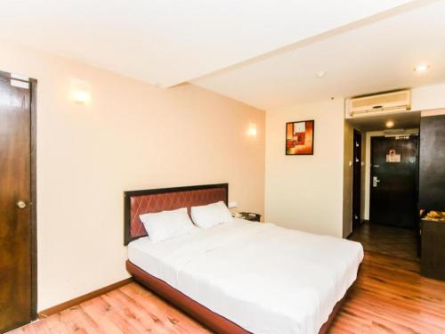 a bedroom with a large white bed in a room at Bay Hotel in Lahad Datu