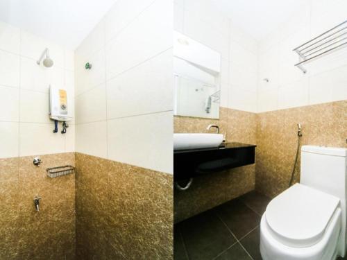 a bathroom with a toilet and a sink at Bay Hotel in Lahad Datu