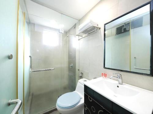 a bathroom with a toilet and a sink and a shower at OYO 718 Mr J Hotel Wakaf Che Yeh 1 in Kota Bharu