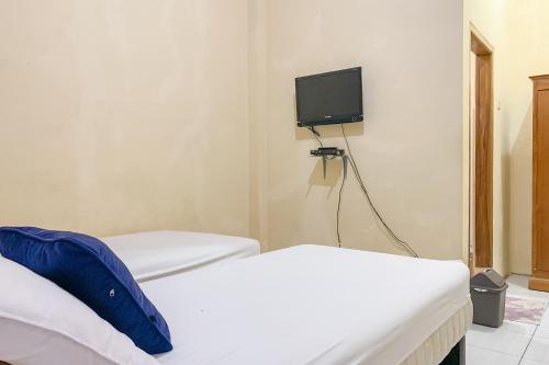Ένα ή περισσότερα κρεβάτια σε δωμάτιο στο Urbanview Hotel Hikmah Syariah Majalengka