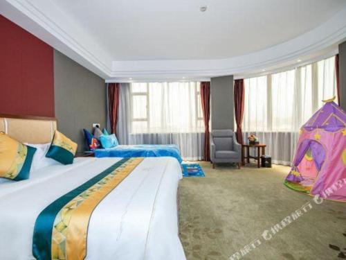 a hotel room with two beds and a tent at Shunde Emperor Hotel in Shunde