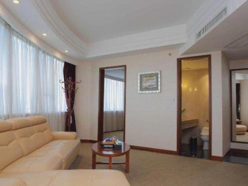 a living room with a couch and a table at Shunde Emperor Hotel in Shunde