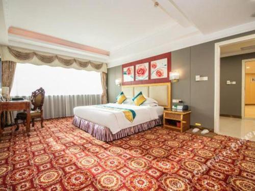 a large hotel room with a bed and a desk at Shunde Emperor Hotel in Shunde
