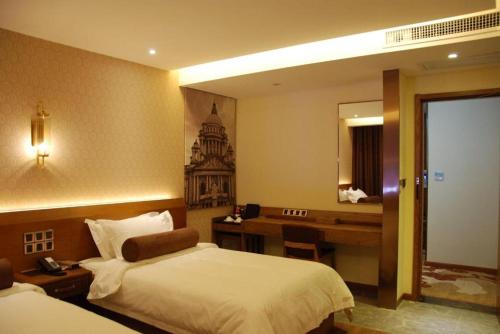a hotel room with a bed and a desk at James Joyce Coffetel Xian Big Goose Pagoda Tang Paradise Branch in Xi'an