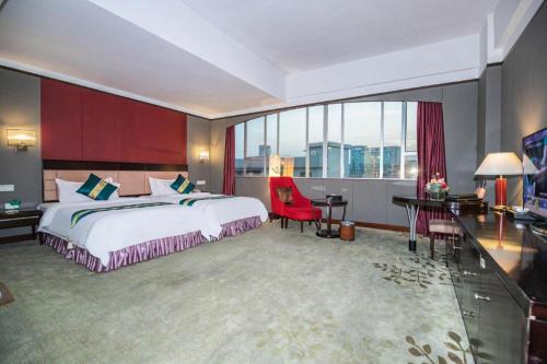 a hotel room with a bed and a large window at Shunde Emperor Hotel in Shunde