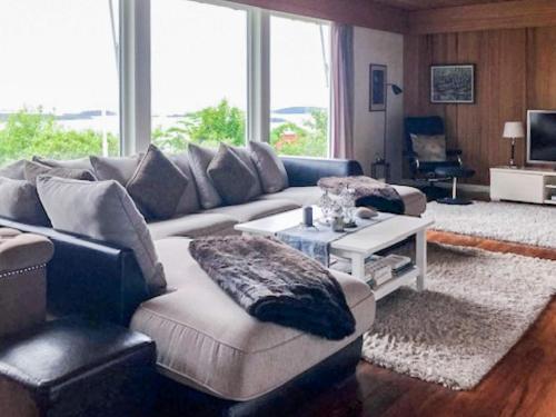 a living room with a couch and a table at 7 person holiday home in Molde in Molde