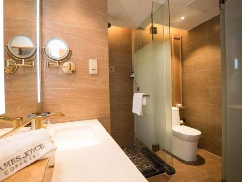 a bathroom with a sink and a toilet at James Joyce Coffetel· Hefei Anhui Agricultural University in Hefei