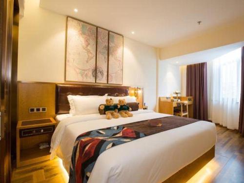 a hotel room with a large bed with teddy bears on it at James Joyce Coffetel· Hefei Anhui Agricultural University in Hefei