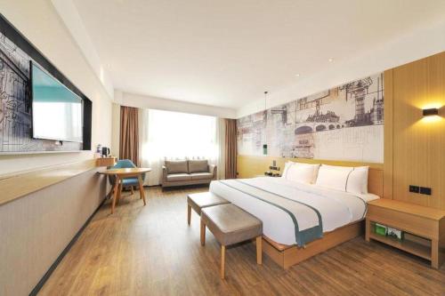 a hotel room with a large bed and a chair at City Comfort lnn Dayi High-speed Railway Station in Chengdu