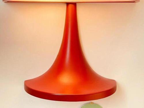 an orange glass vase on a white wall at Q Hotel Shanghai Pudong in Shanghai