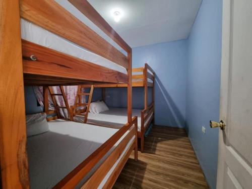 two bunk beds in a room with a hallway at Yemaya de Laiya powered by Cocotel in Batangas City