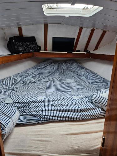 a bed on the bottom bunk of a boat at bateau tinkerbell in Labastide-dʼAnjou