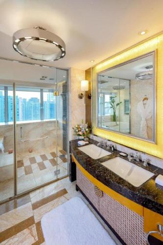 a bathroom with two sinks and a shower at Radegast Hotel CBD in Beijing