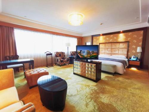 a bedroom with a large bed and a large television at Radegast Hotel CBD in Beijing