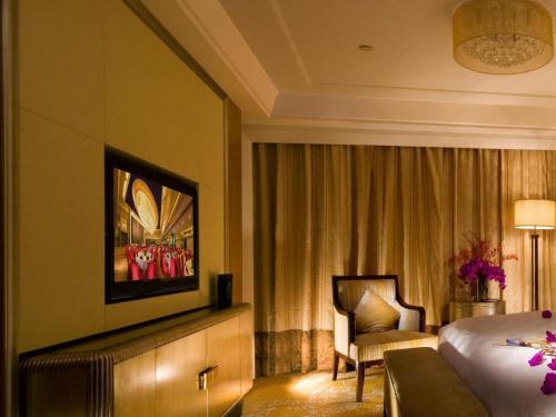 a hotel room with a bed and a television at Radegast Hotel CBD in Beijing