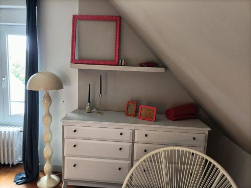 a bedroom with a white dresser and a mirror at Maison au calme, proche du centre de Landerneau in Landerneau