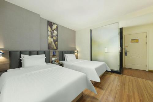Katil atau katil-katil dalam bilik di 7 Days Inn Dongguan Changping Railway Station
