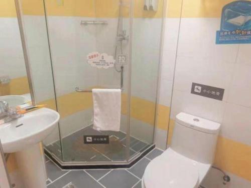 a bathroom with a shower and a toilet and a sink at 7 Days Inn Changchun Zhengyang Street Changchun Park Branch in Changchun