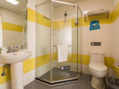 a bathroom with a shower and a toilet and a sink at 7 Days Inn Changchun Zhengyang Street Changchun Park Branch in Changchun