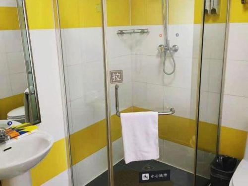 a bathroom with a shower and a sink at 7 Days Inn Changchun Zhengyang Street Changchun Park Branch in Changchun