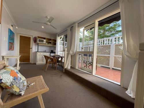 a living room with a large window and a kitchen at The Castle - Villa by the Sea in Cowes